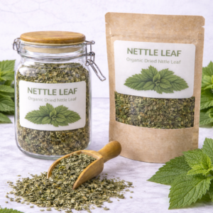 Glass jar of handcrafted herbal tea blend featuring dried rose petals, mugwort leaves, and wormwood arranged on a rustic wooden surface with soft natural lighting.